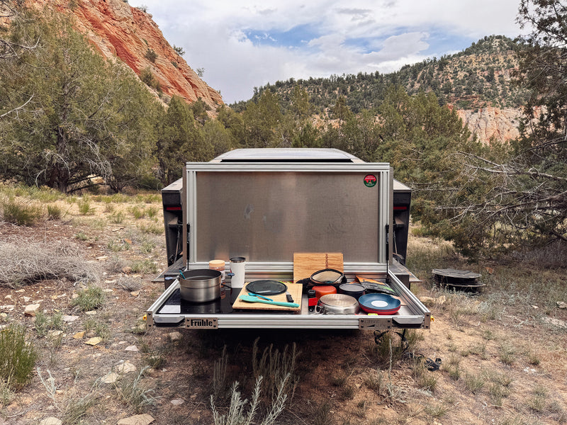 Tesla Cybertruck CyberSlide lifestyle shot showing outdoor adventure cargo setup