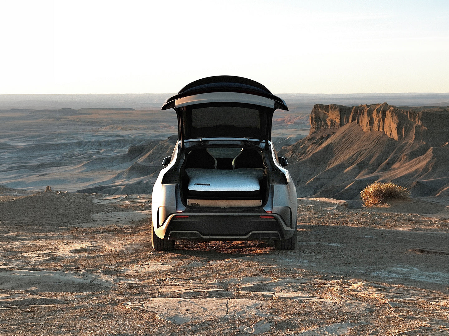 Fruble Ultralite camping kit in a Tesla Model Y in a desert landscape