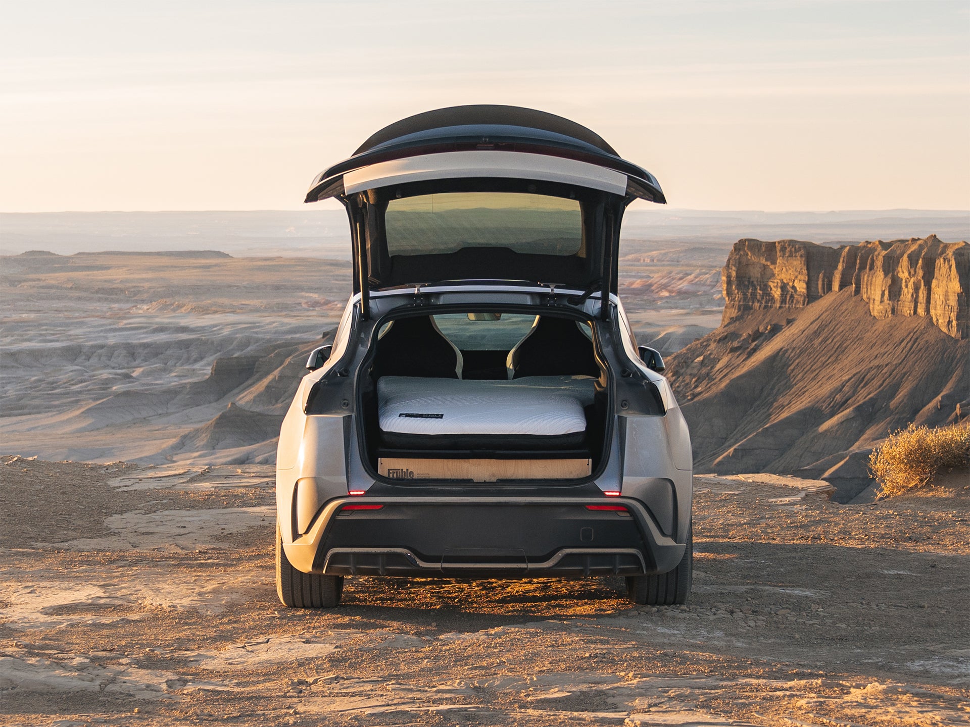 Fruble Ultralite camping kit in a Tesla Model Y in a desert landscape